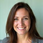 Jennifer Thompson, Head of Wellness at AuraWell and certified wellness coach, looking approachable.