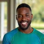 Marcus Thompson, a smiling African American man with athletic build, in activewear.